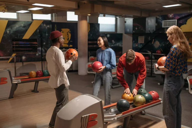 people bowling at a bowling alley