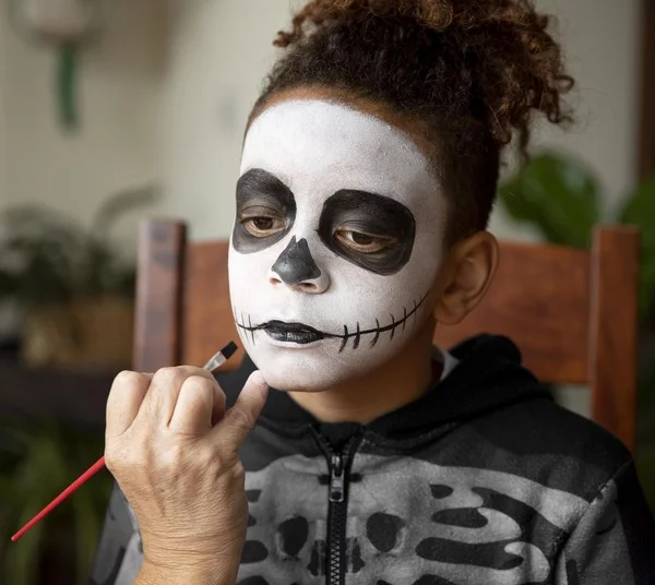 little-girl-preparing-halloween-with-skeleton-costume-2