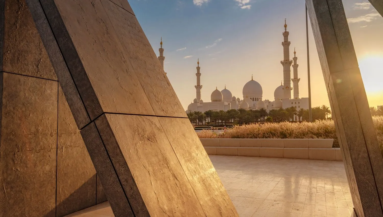 Wahat Al Karama monument during sundown with Sheikh Zayed Grand Mosque in the background