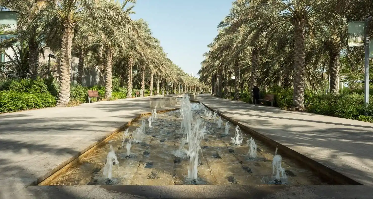 Palm-lined promenade with water fountains at Umm Al Emarat Park in Abu Dhabi