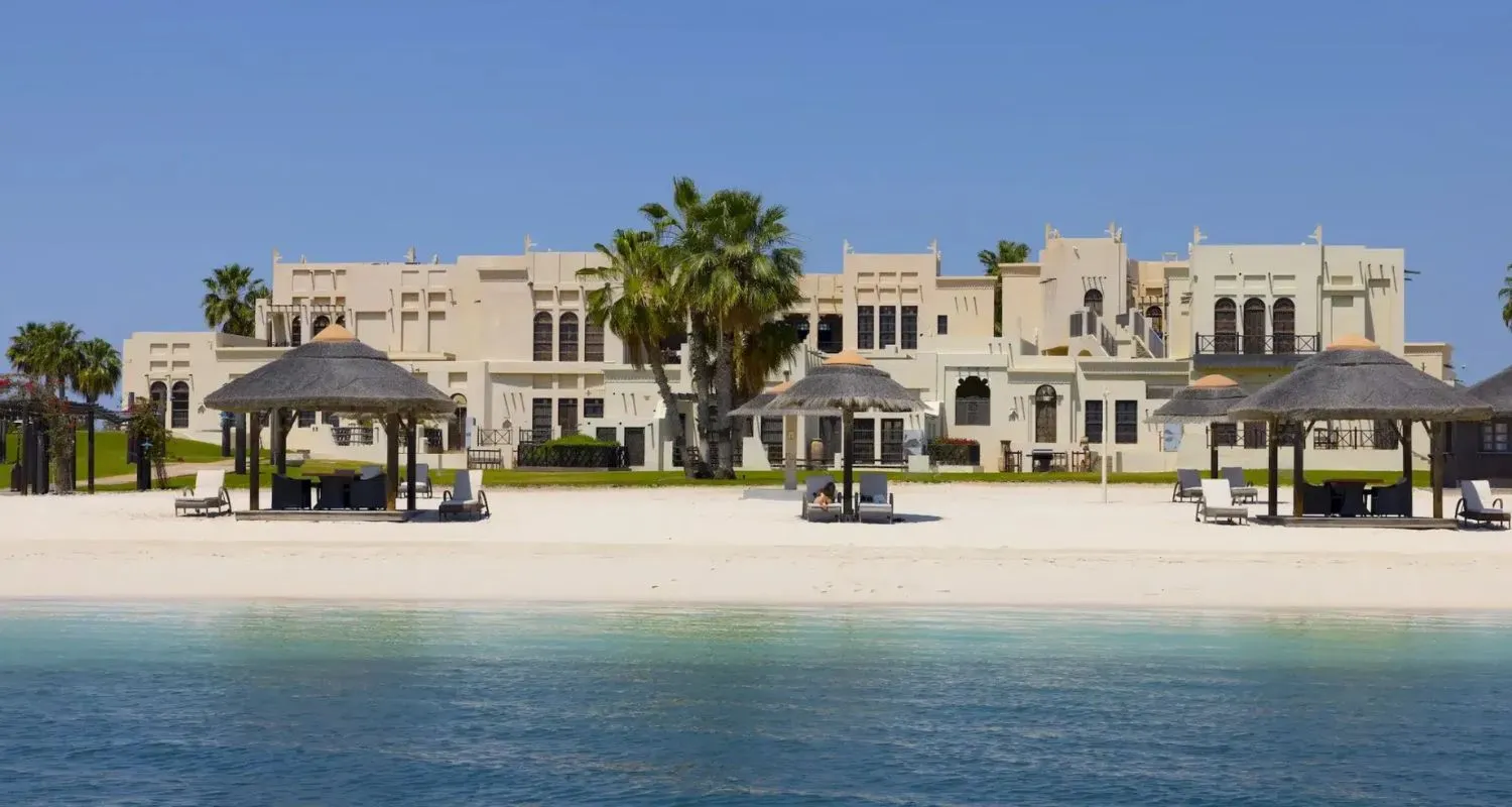 White beachfront villas and shaded cabanas at Al Maya Island & Resort off the Abu Dhabi coast